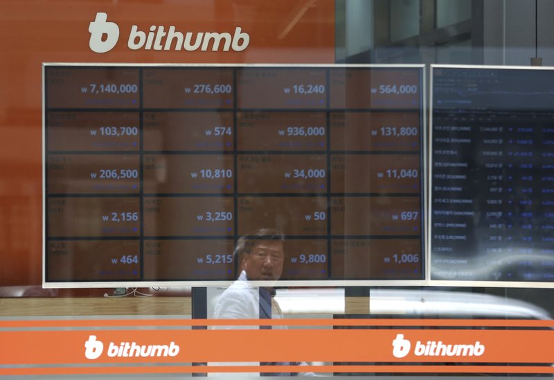 A man is reflected on a screen showing the prices of bitcoin at Bithumb cryptocurrency exchange in Seoul, South Korea, on Wednesday, June 20, 2018. Ahn Young-joon—AP Photo
