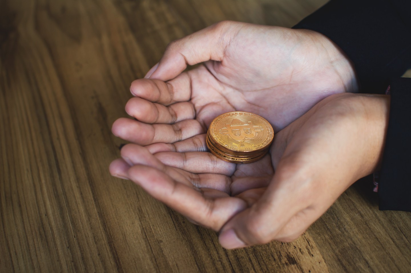 Cropped Hands Holding Bitcoins