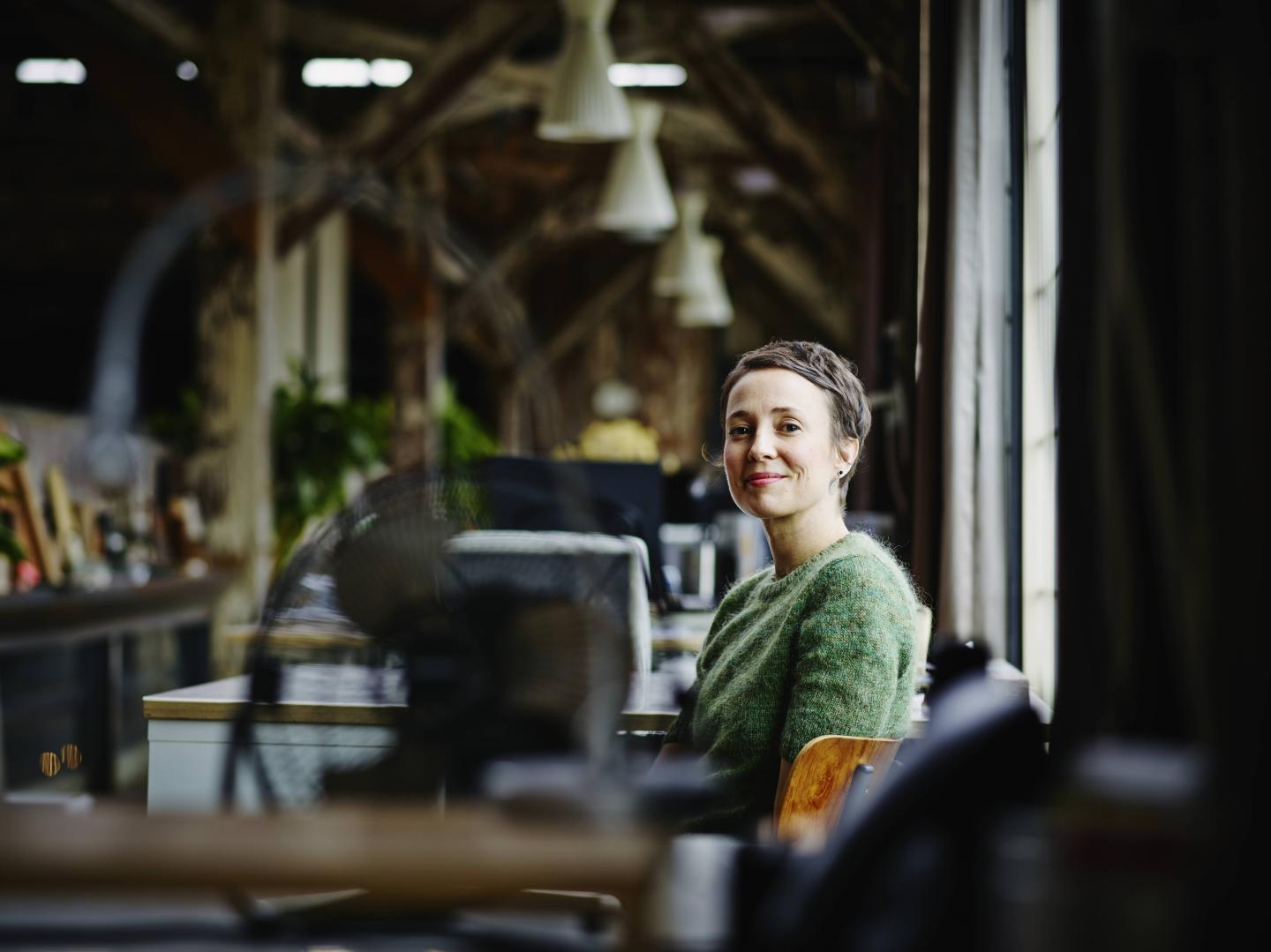 Smiling businesswoman sitting at workstation