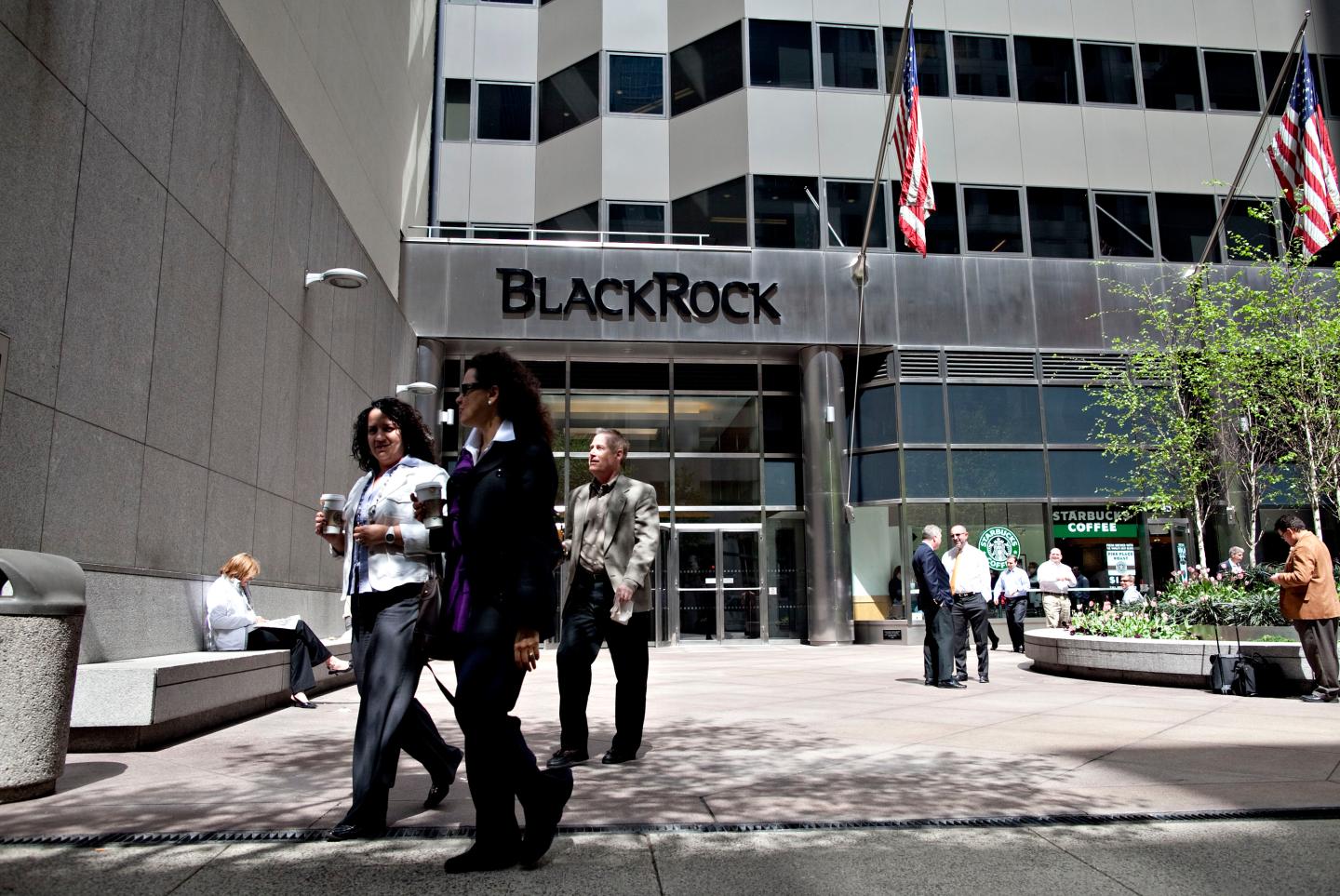 Pedestrians walk outside the headquarters of BlackRock Inc.