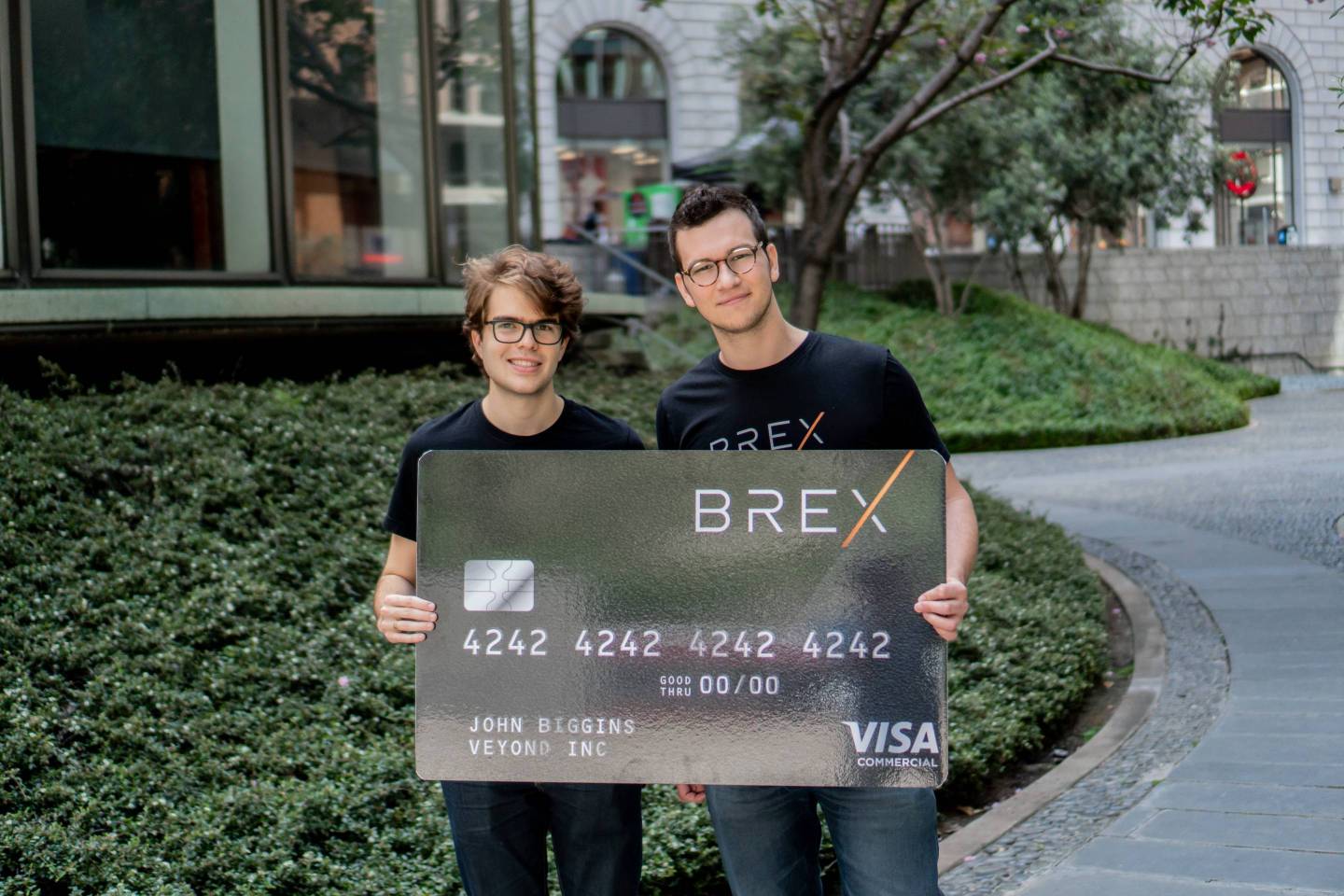 Brex cofounders Pedro Franceschi (left) and Henrique Dubugras, CEO, hold up an oversized version of the credit card they are providing to other startups.