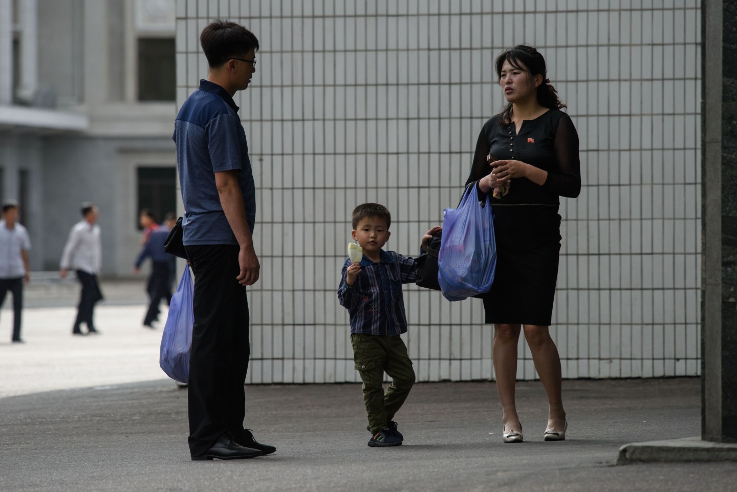 A family stands outside a department store in Pyongyang.