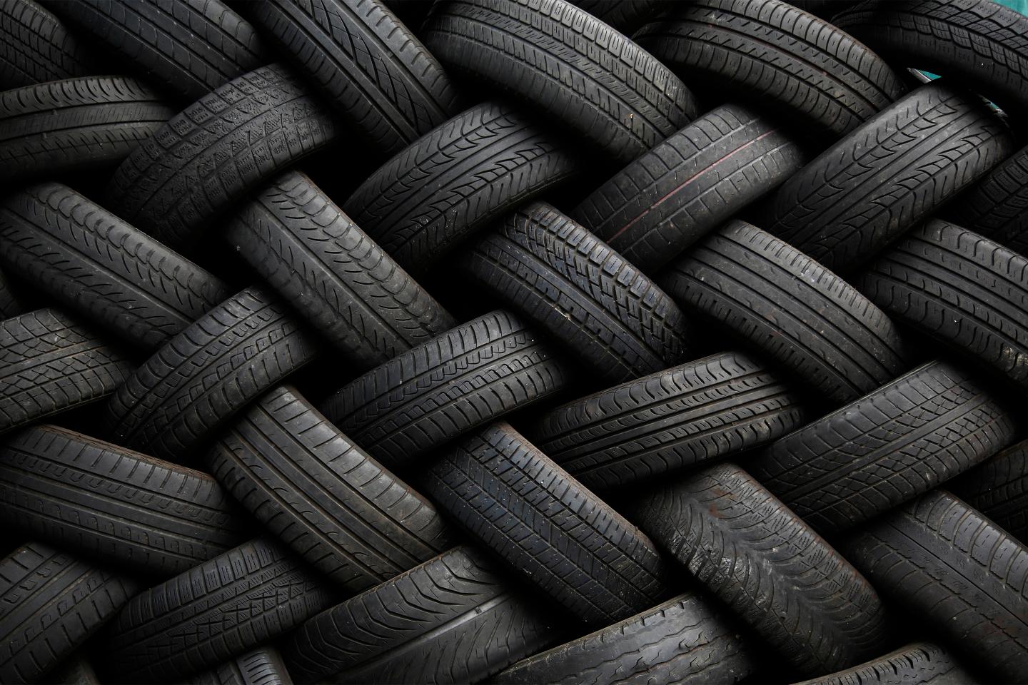 Used car tires form a pattern as they are seen stacked outside an automotive shop in East Dulwich, south London