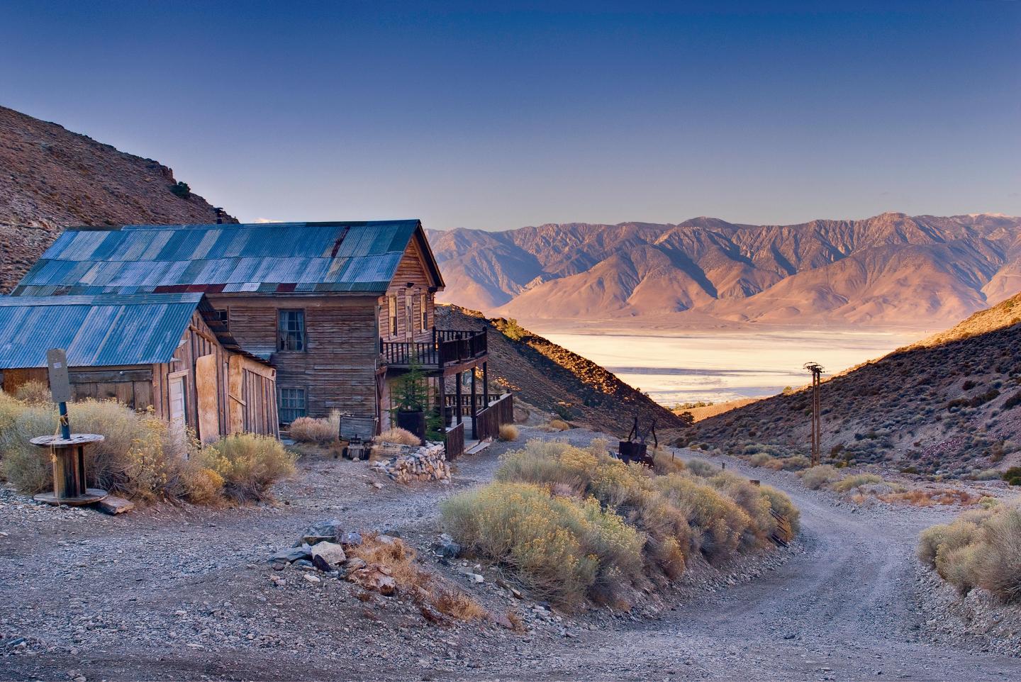 Abandoned American Hotel, Cerro Gordo ghost town in Inyo Mtns, Eastern Sierra Nevada, Owens Lake in distance, California, USA