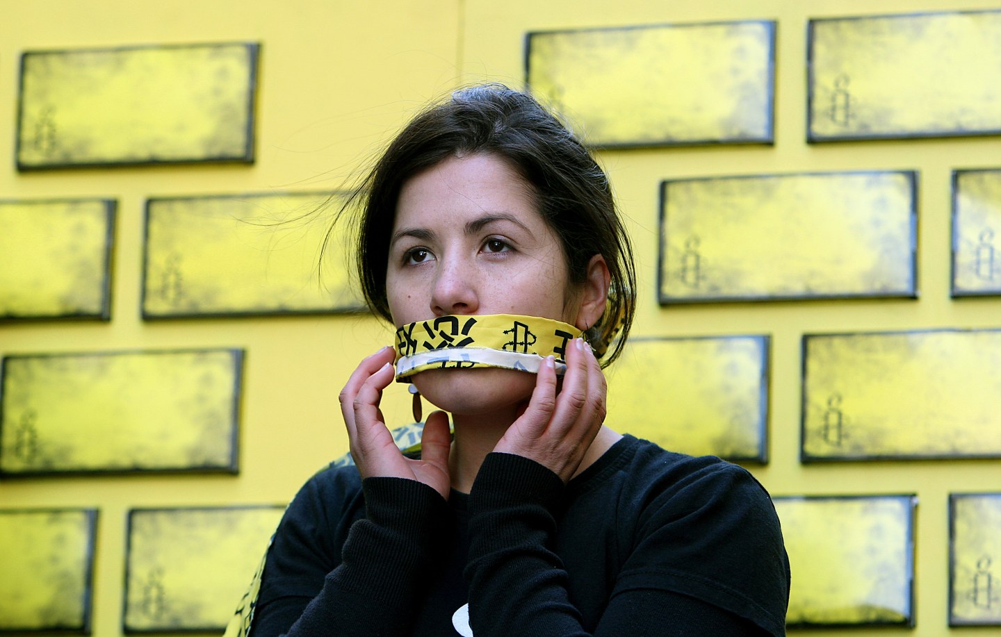 An Amnesty International member covers her mouth during a protest in Sydney against Internet censorship in China.