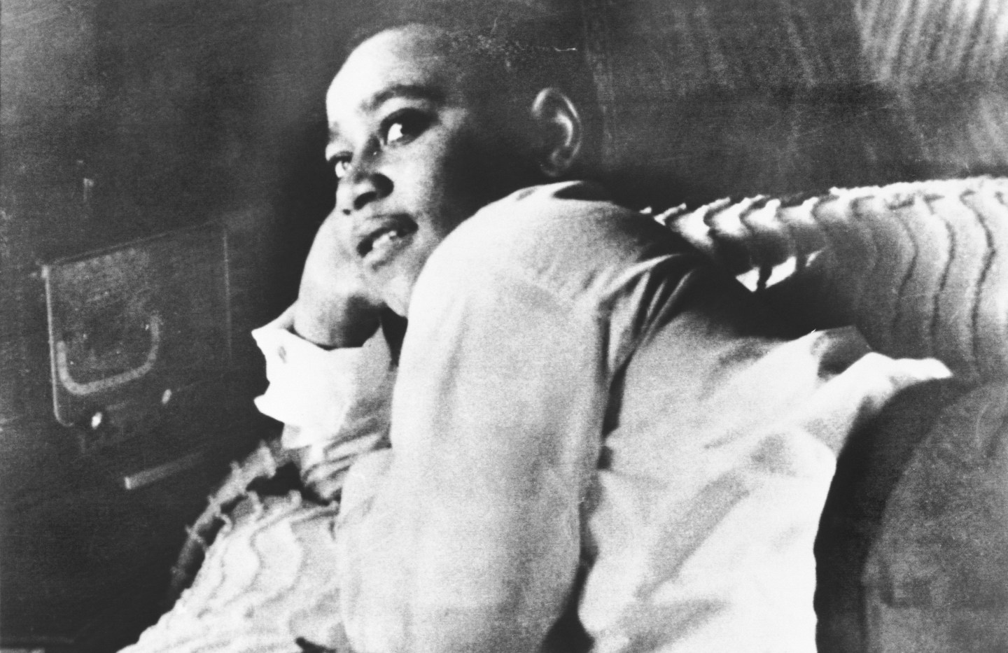 Emmett Till is shown lying on his bed