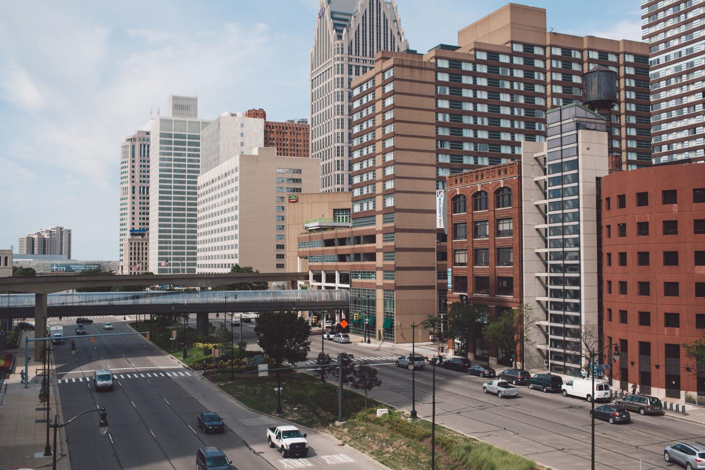 Vehicles On Road In City Against Sky