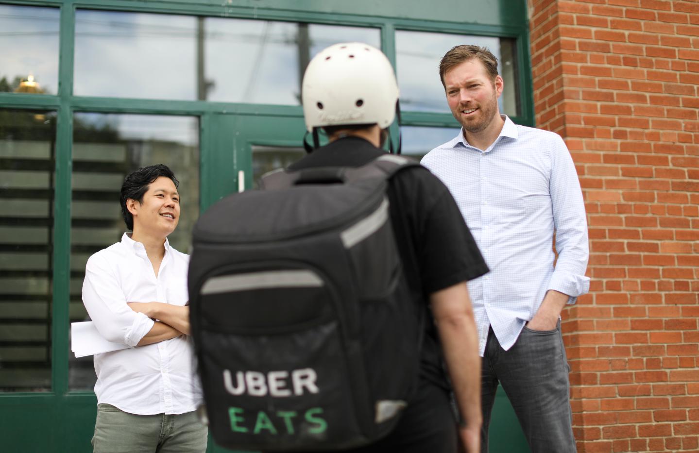 Guy with an Uber Eats backpack making a delivery