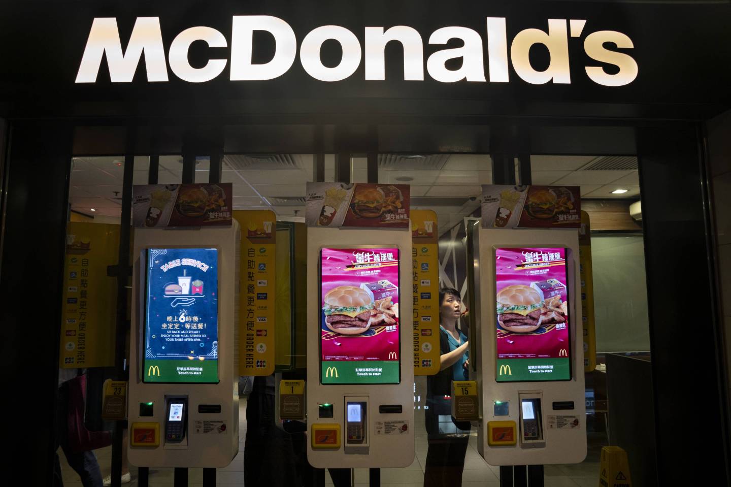 Customers ordering food in automated self-ordering kiosk at