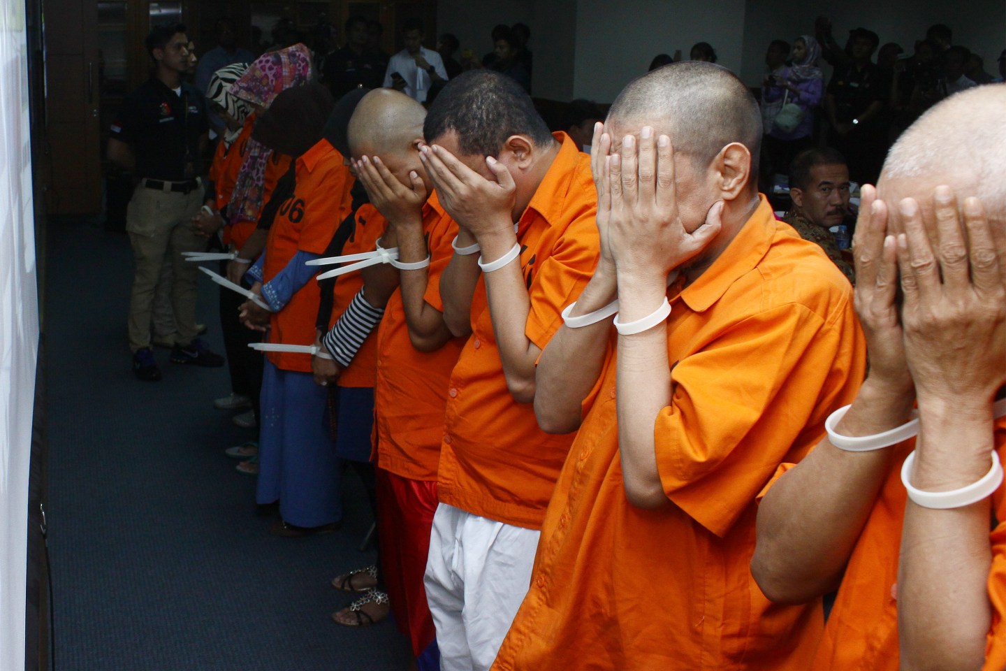 Human trafficking suspects are presented at the Indonesian National Police Criminal Investigation Agency Office in Jakarta.