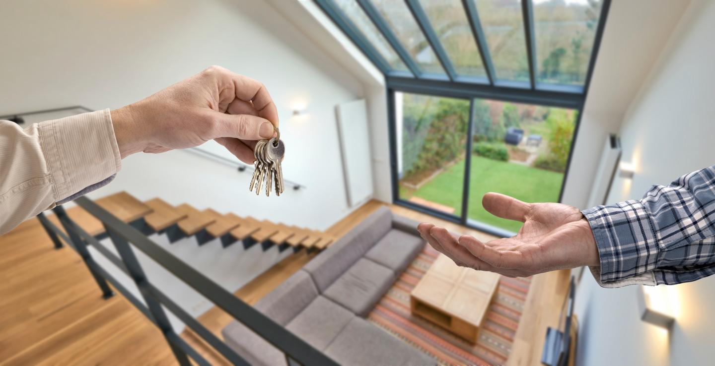 Realtor giving house key to buyer