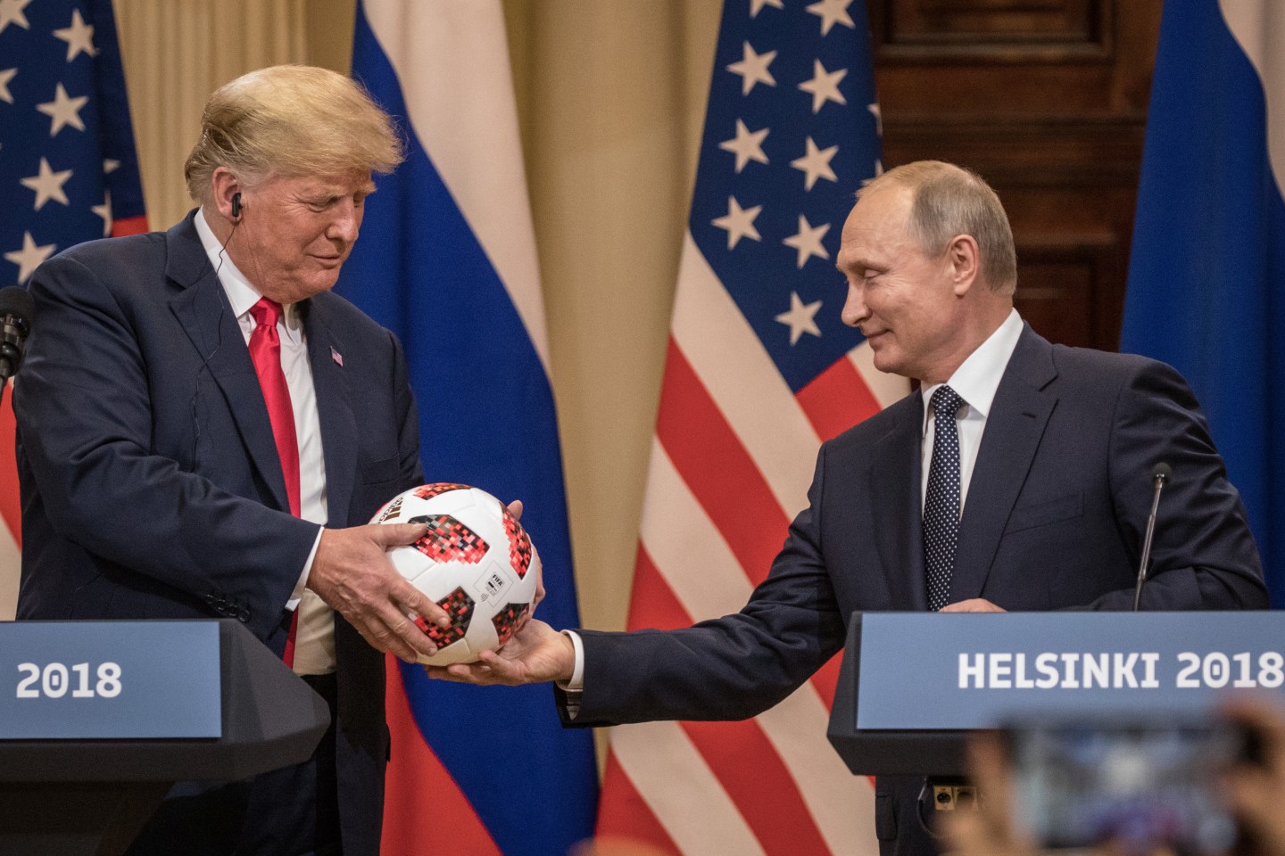 Russian President Vladimir Putin hands U.S. President Donald Trump a World Cup soccer ball during a joint press conference after their summit on July 16, 2018 in Helsinki, Finland.