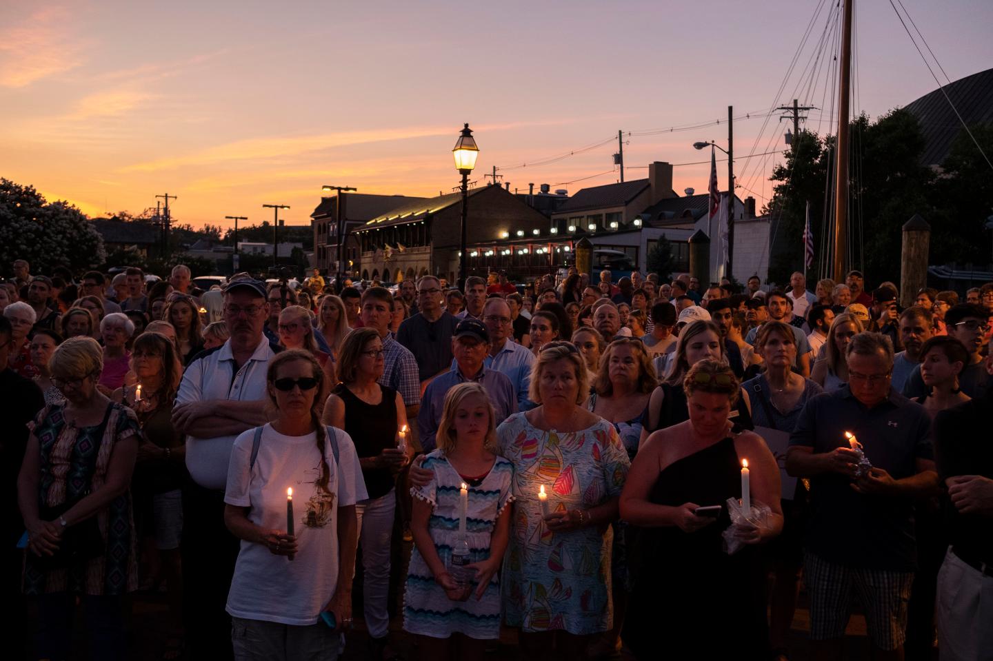 photos involving the Capital Gazette shooting in Annapolis and a candlelight vigil beginning at Lawyer's Mall at the State House, followed by a march to City Dock for a service