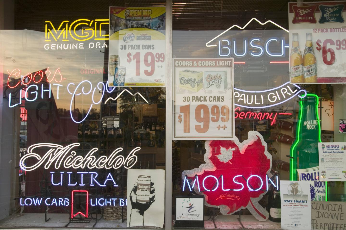Beer signs in neon in liquor store window of Connecticut