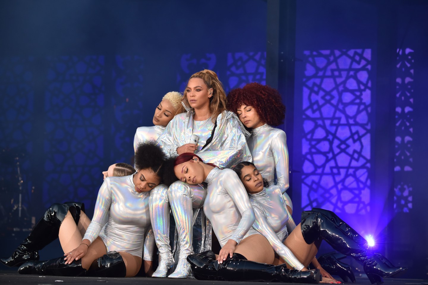 Beyonce (C) with dancers performs on stage, surrounded by backup dancers who lean on her, during the "On the Run II" Tour with Jay-Z at Hampden Park.