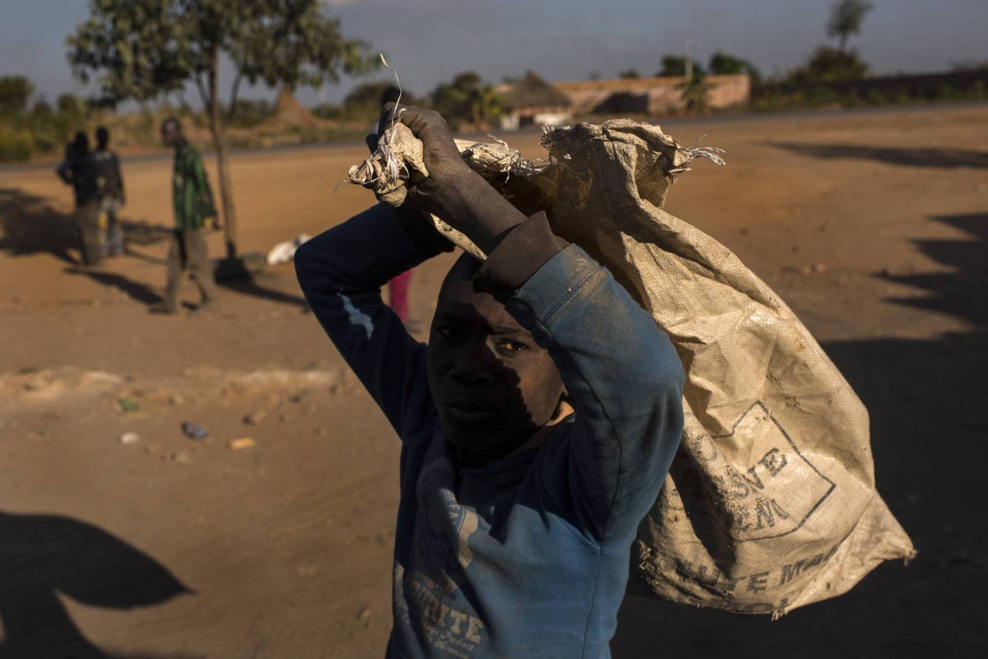 A boy carries a bag of cobalt in Kolwezi, Democratic Republic of the Congo, on June 7, 2016.