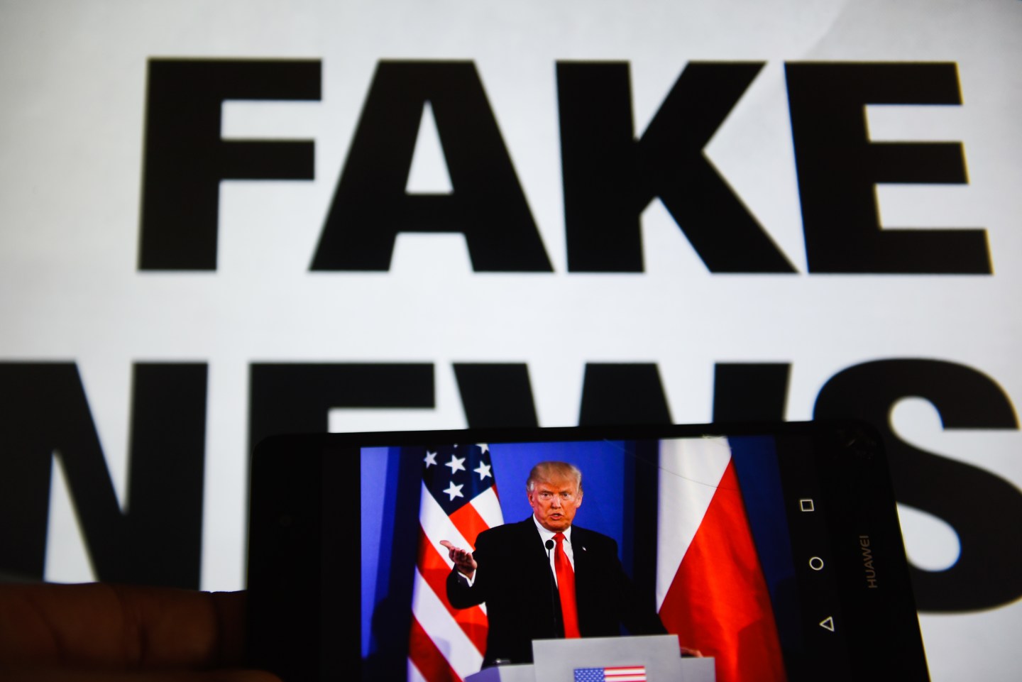 A mobile phone shows President of United States of America,