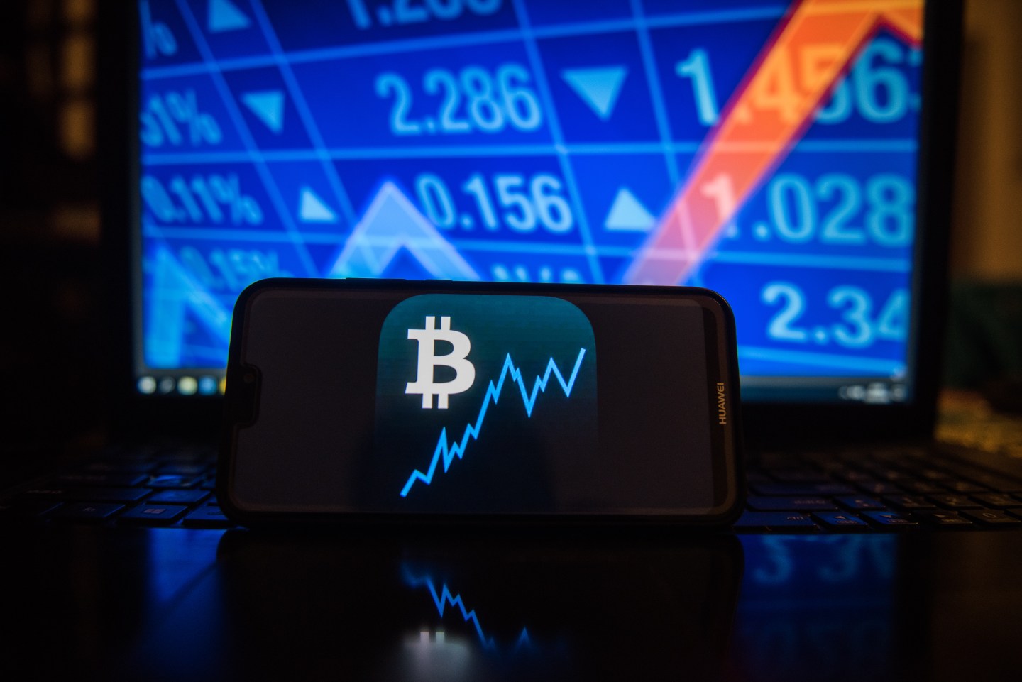 Bitcoin logo is seen on a mobile phone