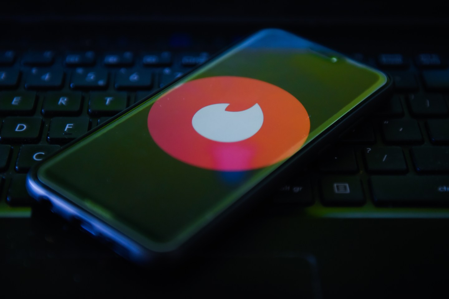 Tinder logo is seen on a mobile phone