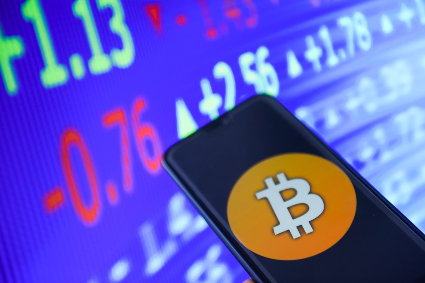 Bitcoin logo is seen on a mobile phone