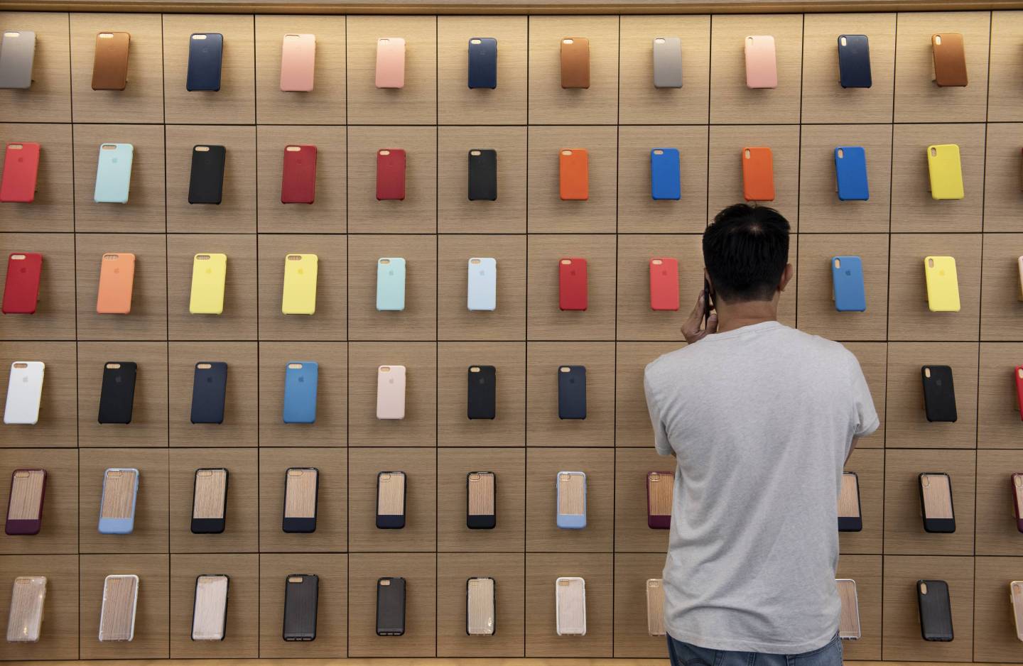 A client looks at a wall  fully occupied with colorful