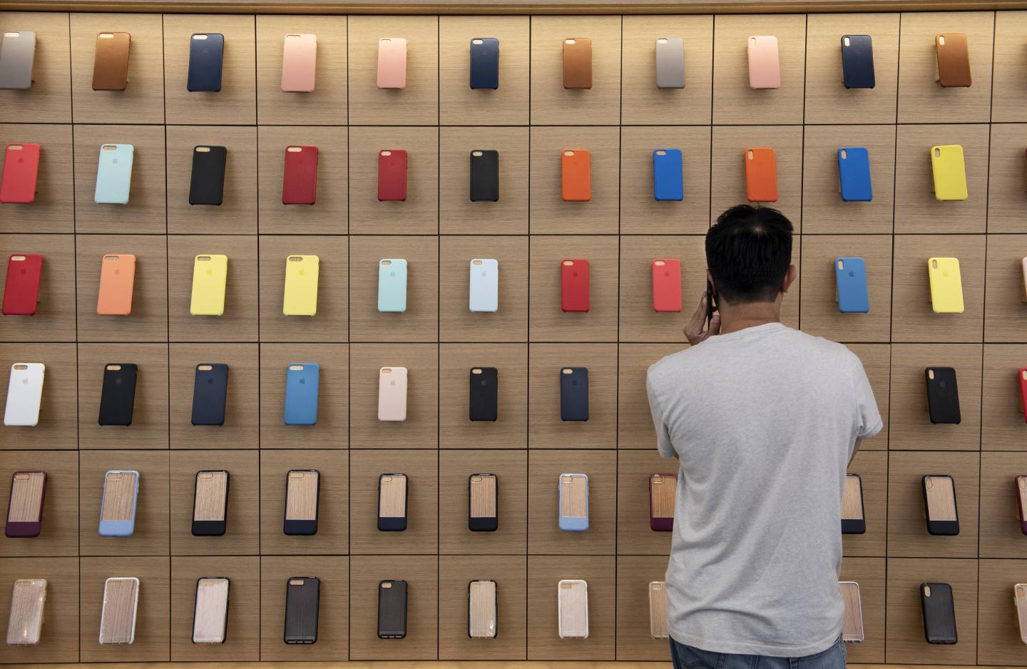 A client looks at a wall  fully occupied with colorful