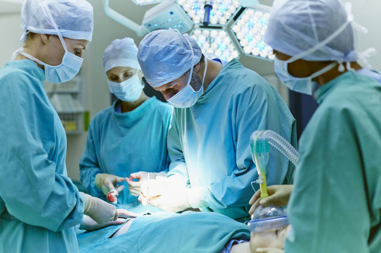Surgeons performing surgery in operating room