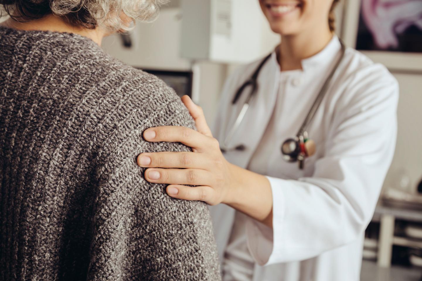Doctor soothing senior patient