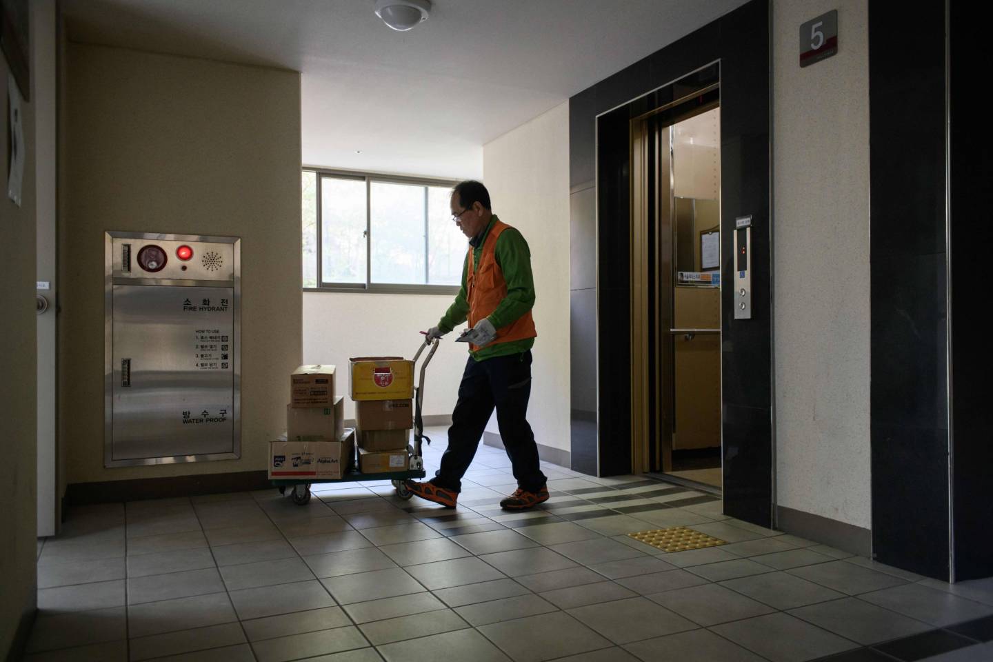 Man unloads equipment from an elevator