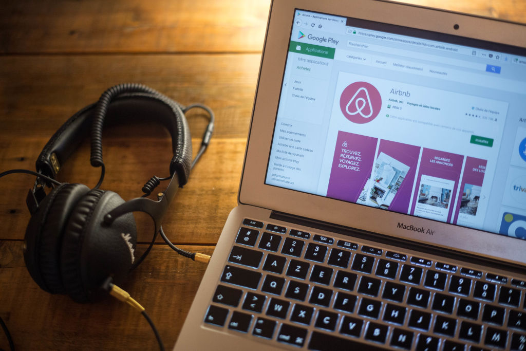 The Airbnb application seen displayed on a Apple MacBook Air