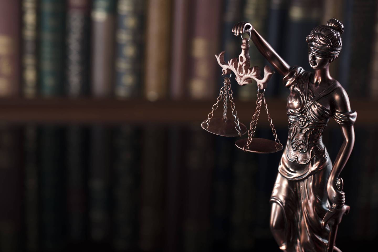 figurine of lady justice holding her scales