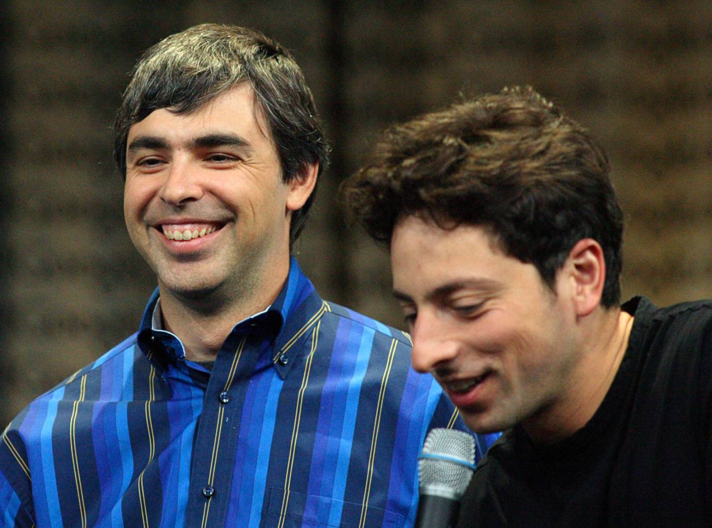 Google co-founders Page and Brin smile during a press conference in Mountain View