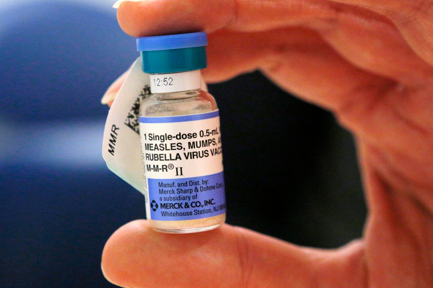 A nurse holds a vial of measles, mumps and rubella vaccine at Boston Children's Hospital in Boston