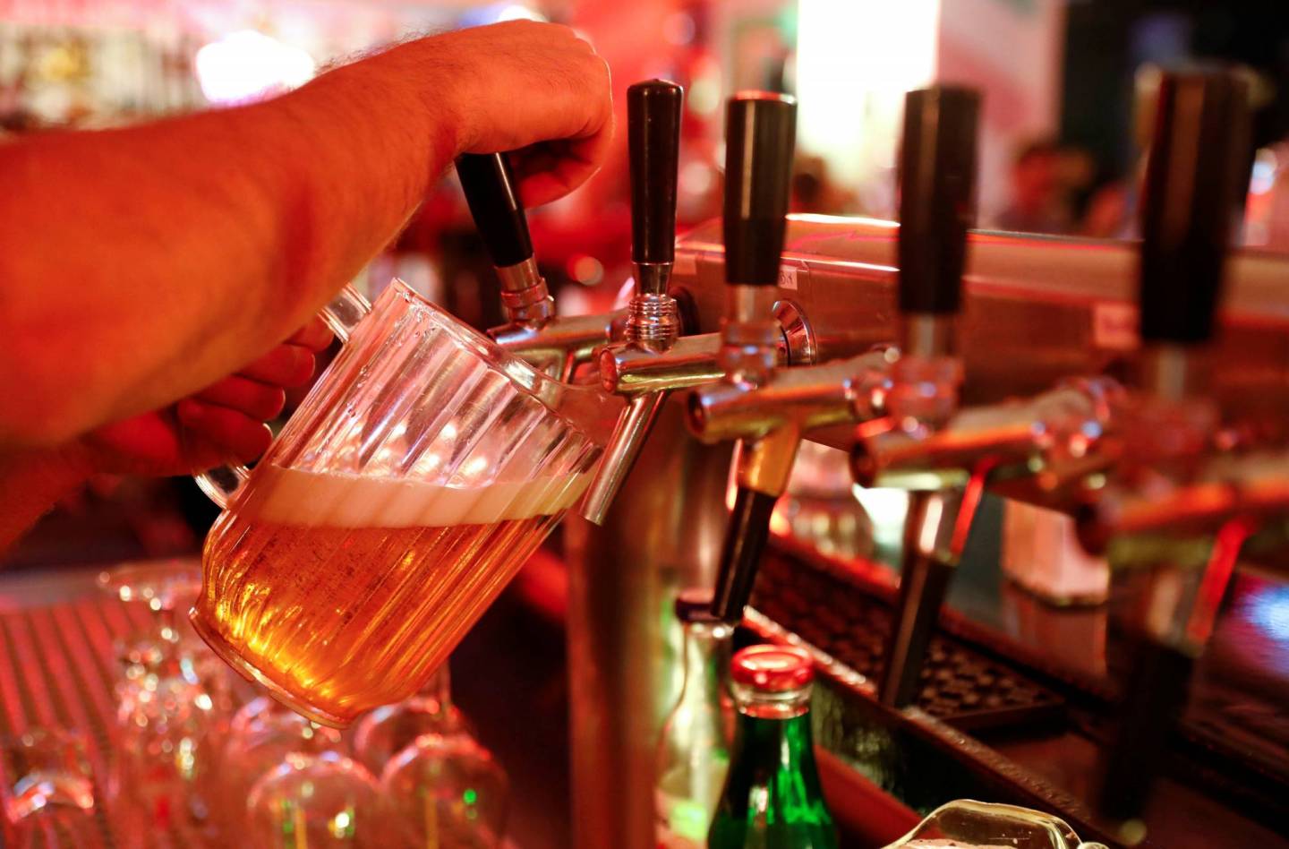A barkeeper pours Budweiser beer from the tap at "Route 66 Diner", which offers American diner food, in Berlin