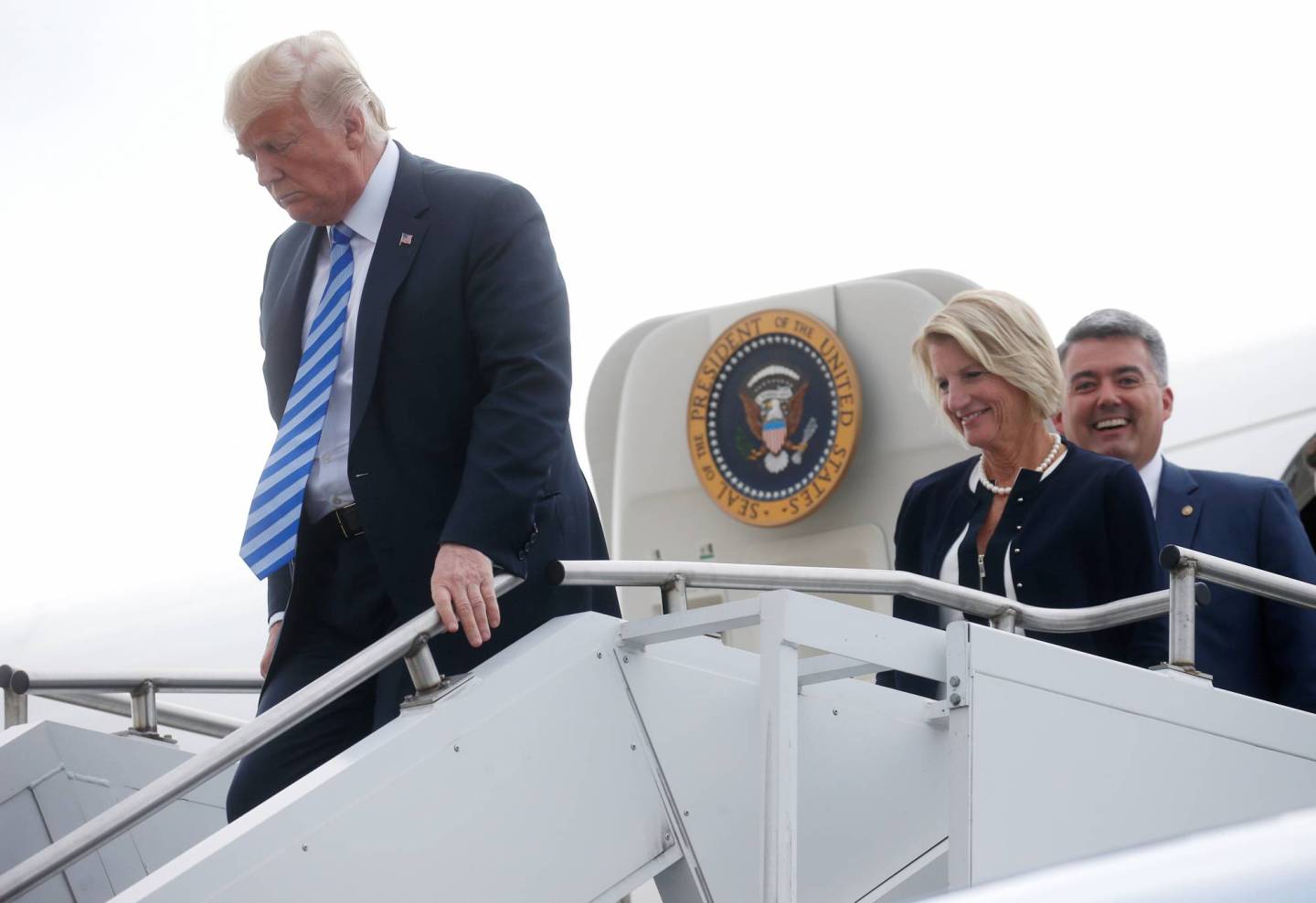 President Trump walks off Air Force One with Republican U.S. Senators as he arrives in Charleston, West Virginia