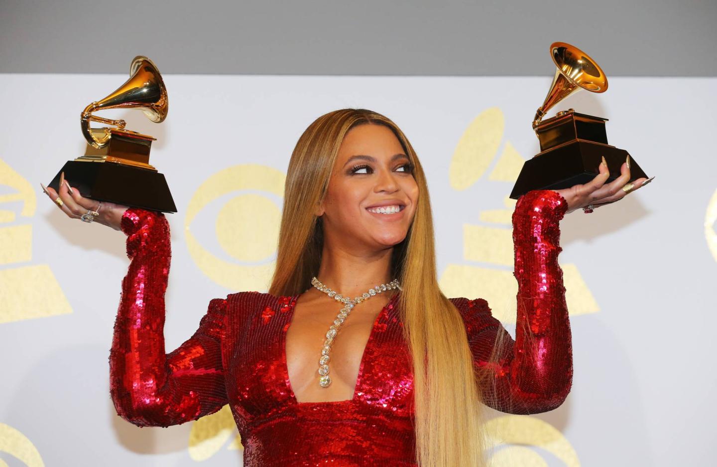 Beyonce holds the awards she won at the 59th Annual Grammy Awards in Los Angeles