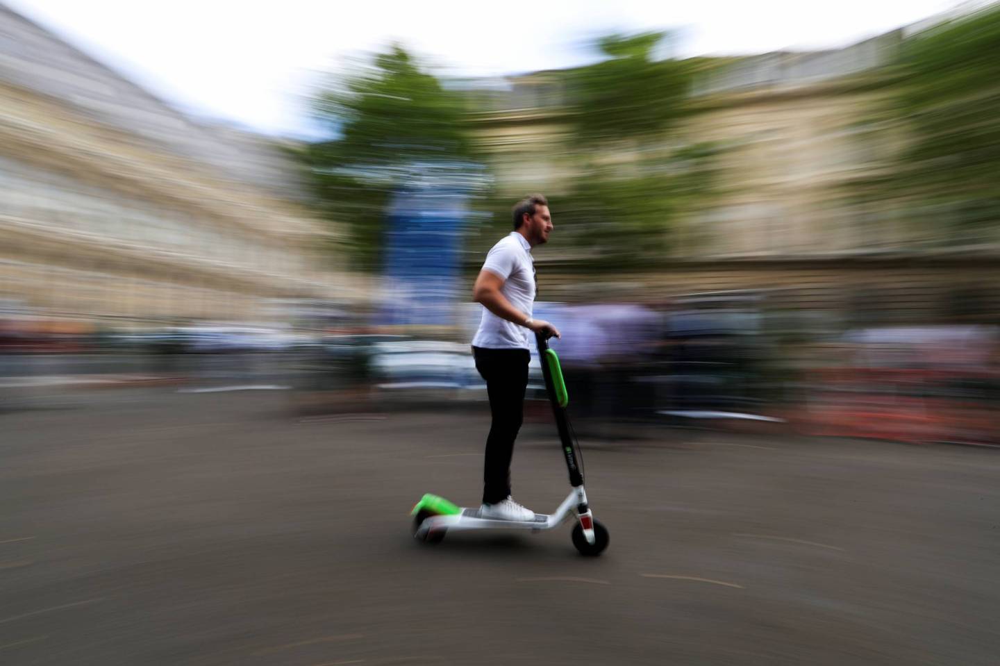 A man rides a dock-free electric scooter Lime-S by California-based bicycle sharing service Lime during a presentation of new alternative urban mobility options at Paris city hall