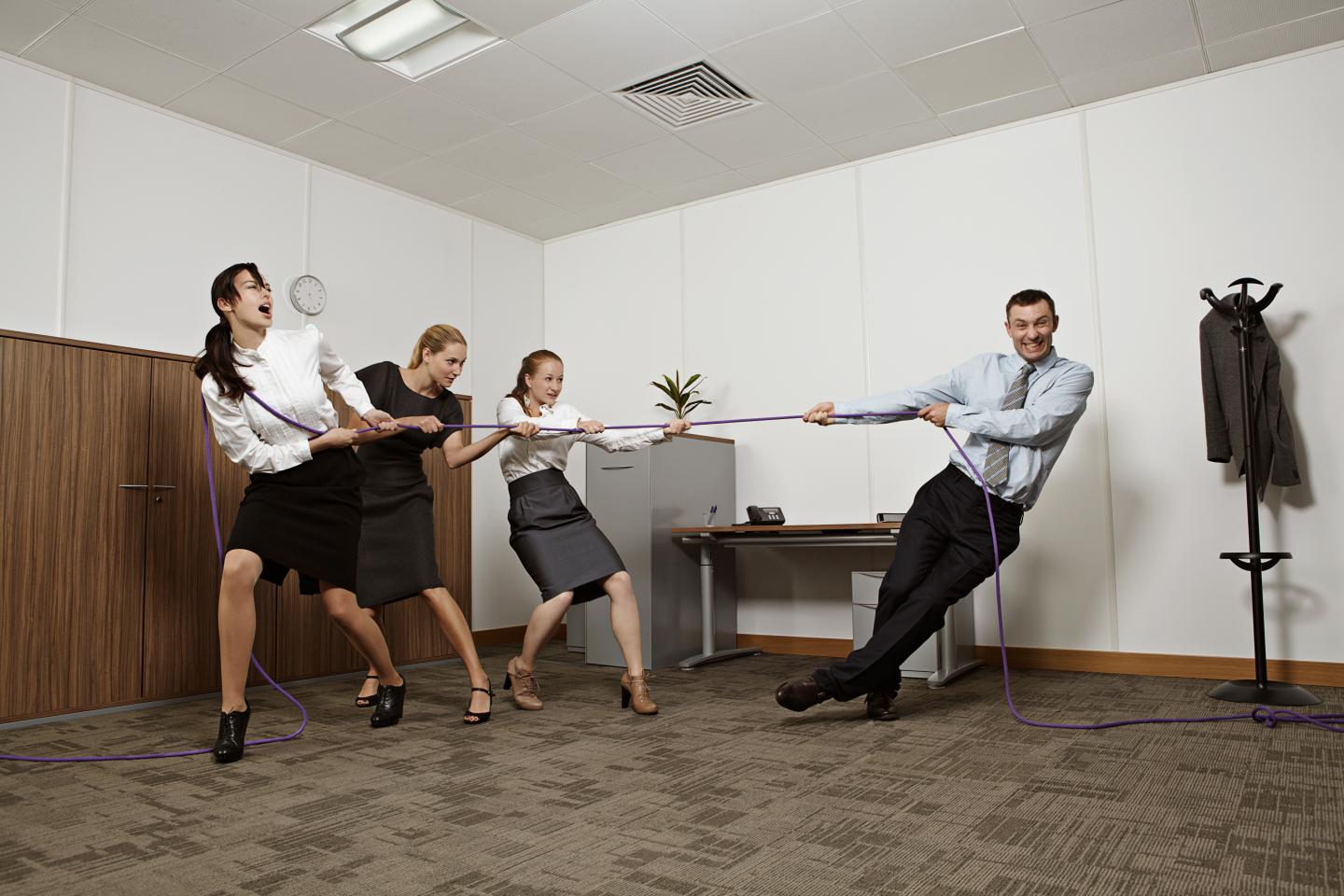 Coworkers playing tug-of-war