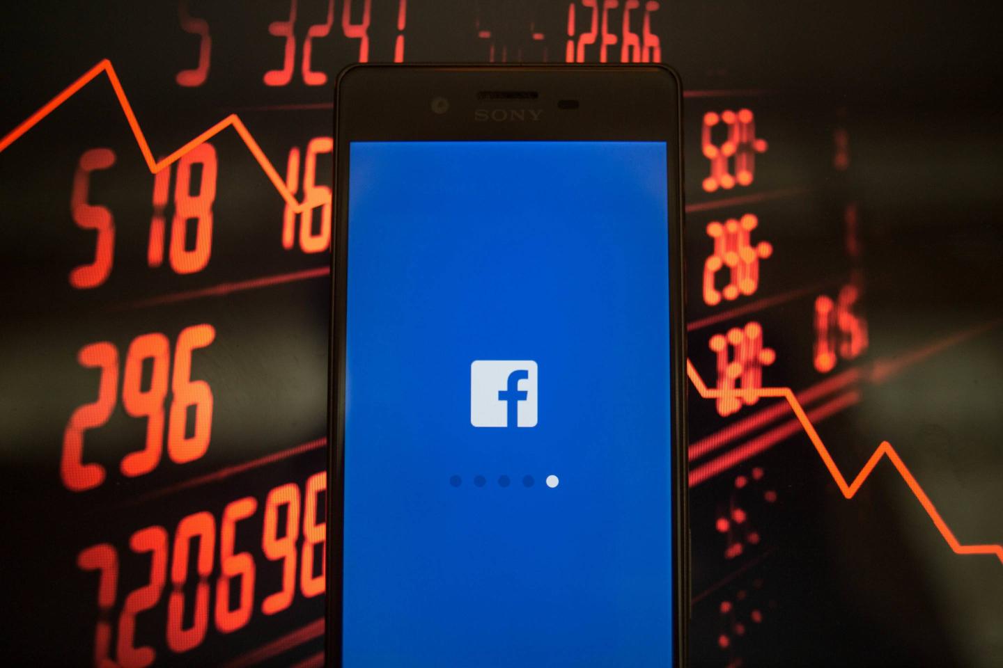 A smartphone displays the Facebook application with a
