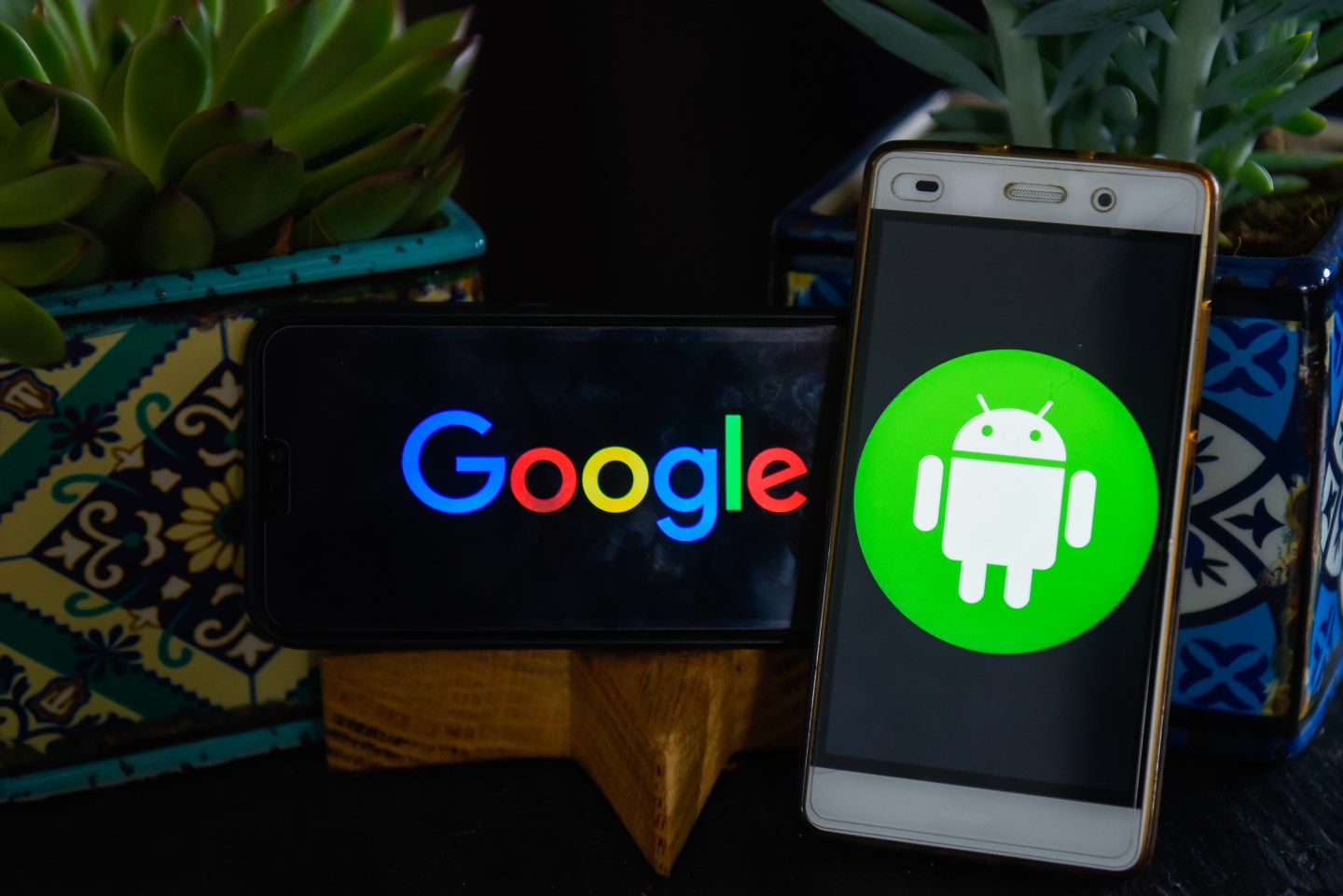 Google and Android logos are seen on Android mobile devices
