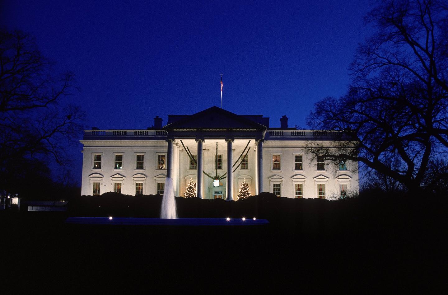 Exterior facade of White House at night. December,