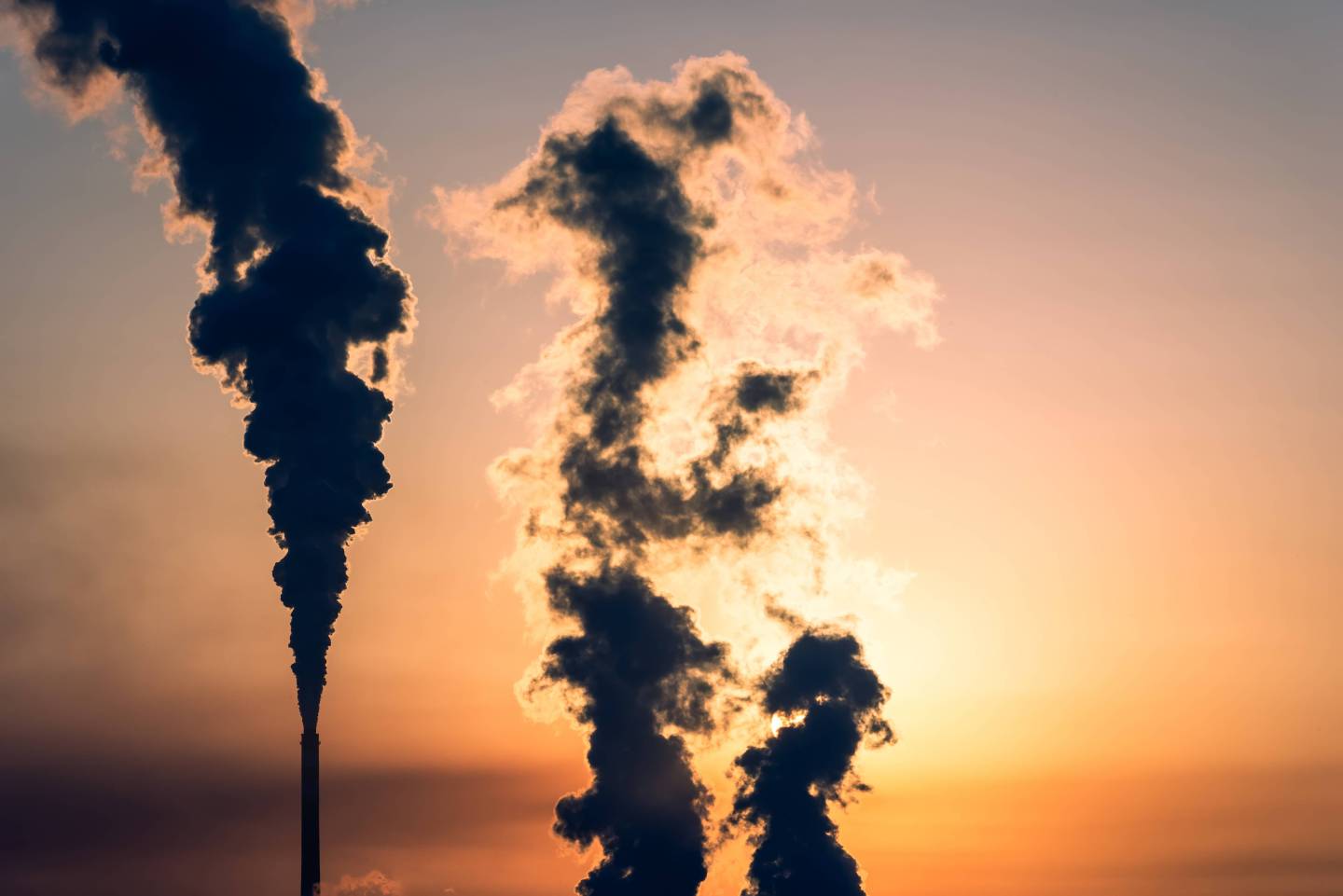 An industrial smokestack in silhouette in Zhangjiakou, Hebei, China.