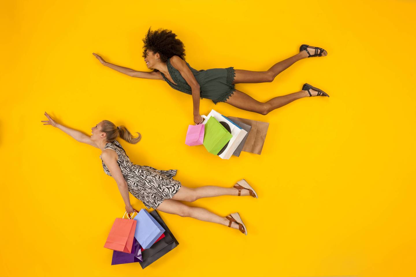 Two women coming from a shopping spree, carrying shopping bags