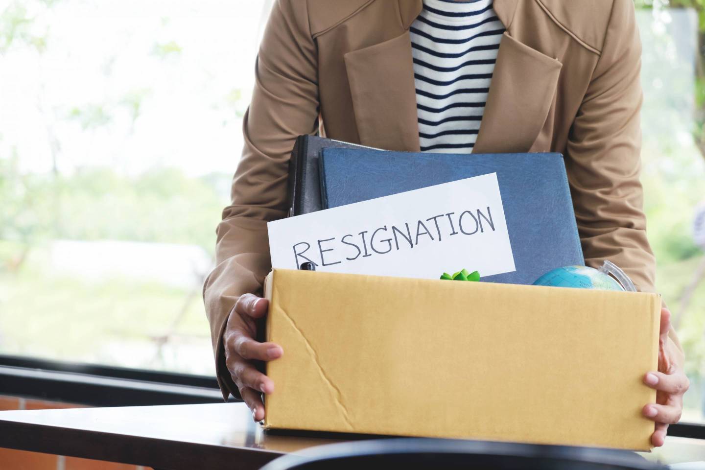 Midsection Of Businessman Holding Box With Text