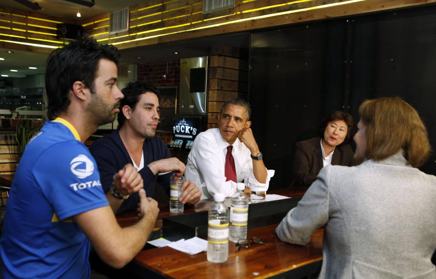 U.S. President Obama talks with small business owners to discuss income tax credits in Washington