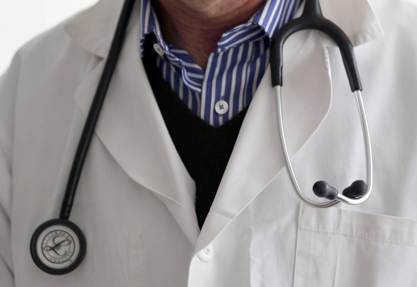 A photo illustration shows a French general practitioner with a stethoscope in a doctor's office in Bordeaux