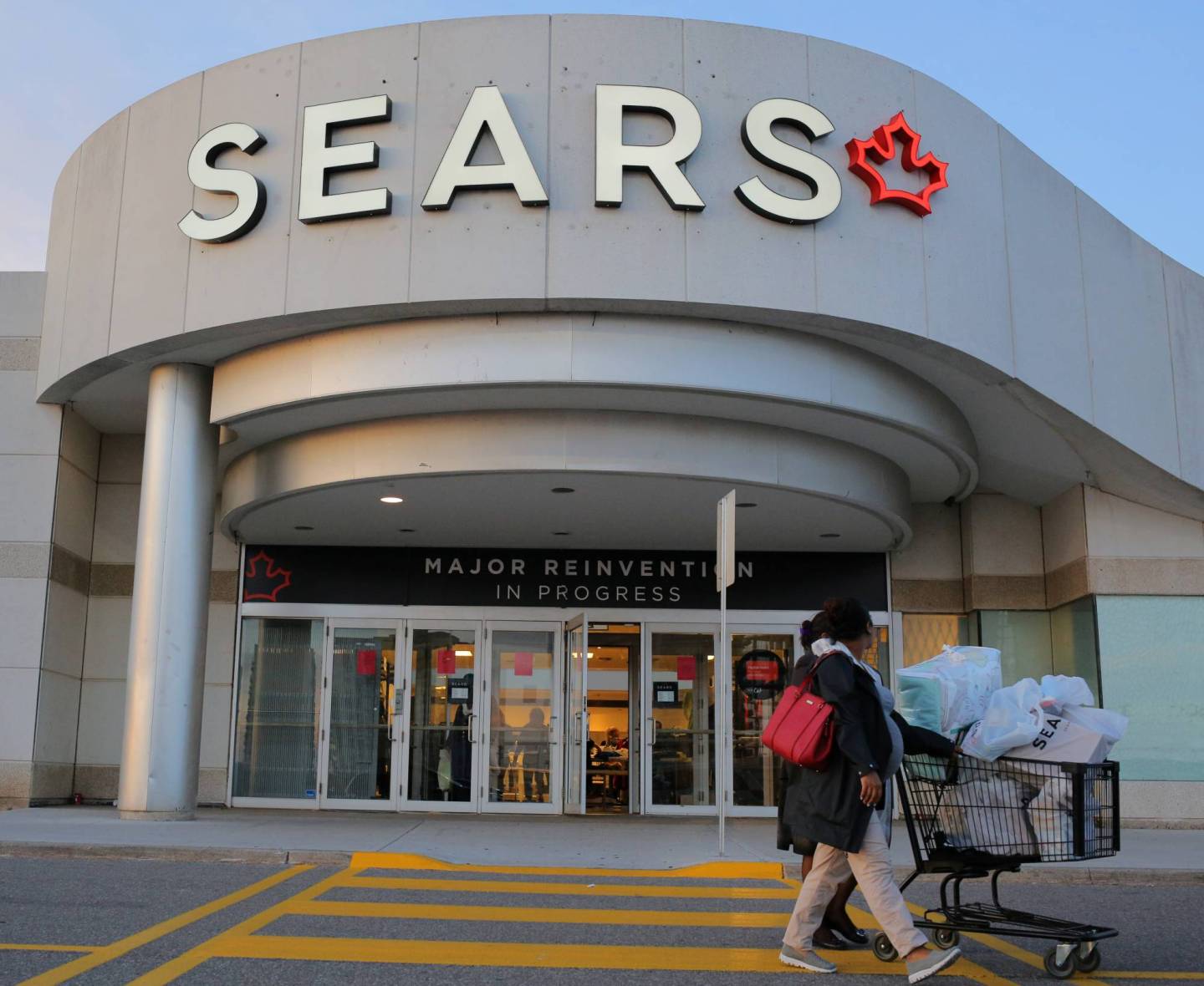 Shoppers leave a Sears store on the first day of liquidation sales in Mississauga