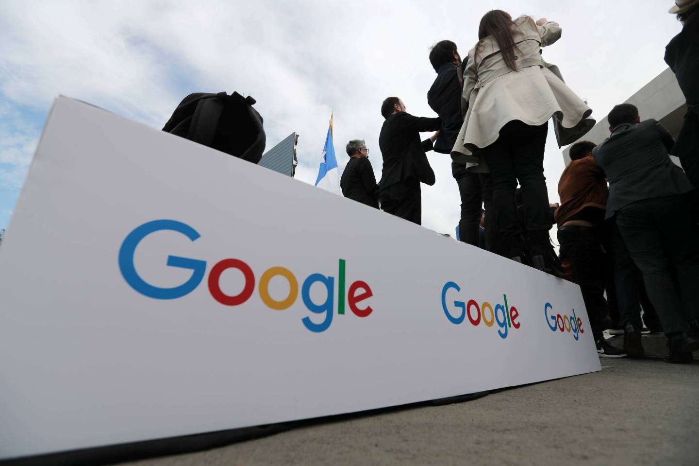 Guests stand on a podium with the Google logo during the announcement of the plans for their data centre expansion in Santiago