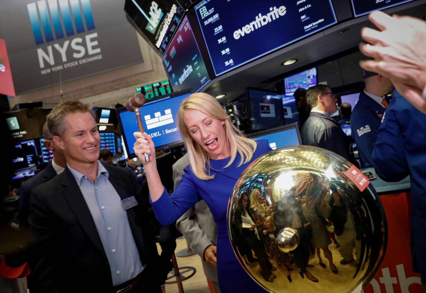 Eventbrite Inc. CEO Julia Hartz stands next to her husband Kevin Hartz, Co-Founder and Chairman of Eventbrite, as she rings a ceremonial bell to celebrate their company's IPO at the NYSE in New York