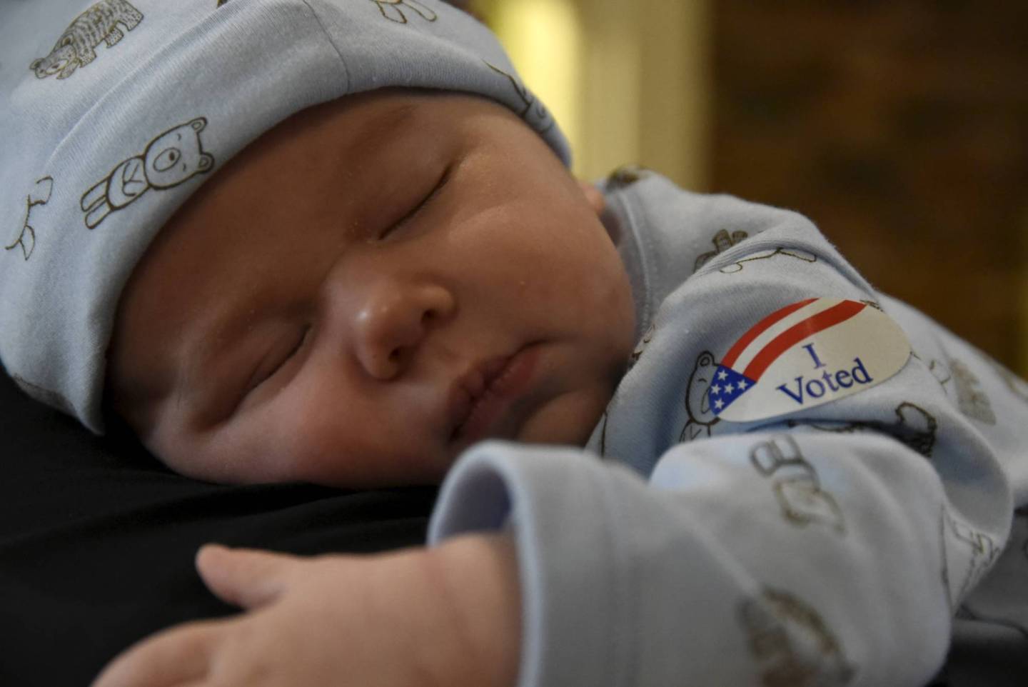 Brewer Hickman, 6 weeks old, takes a nap as his dad Nicholas Hickman votes at the North Park Mall on Super Tuesday in Oklahoma City